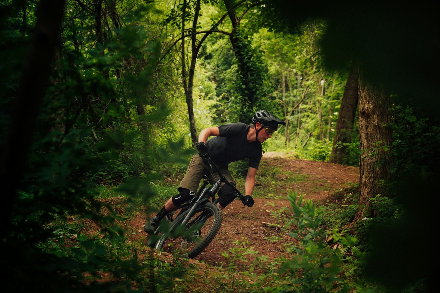Vététiste en action sur un sentier technique en forêt