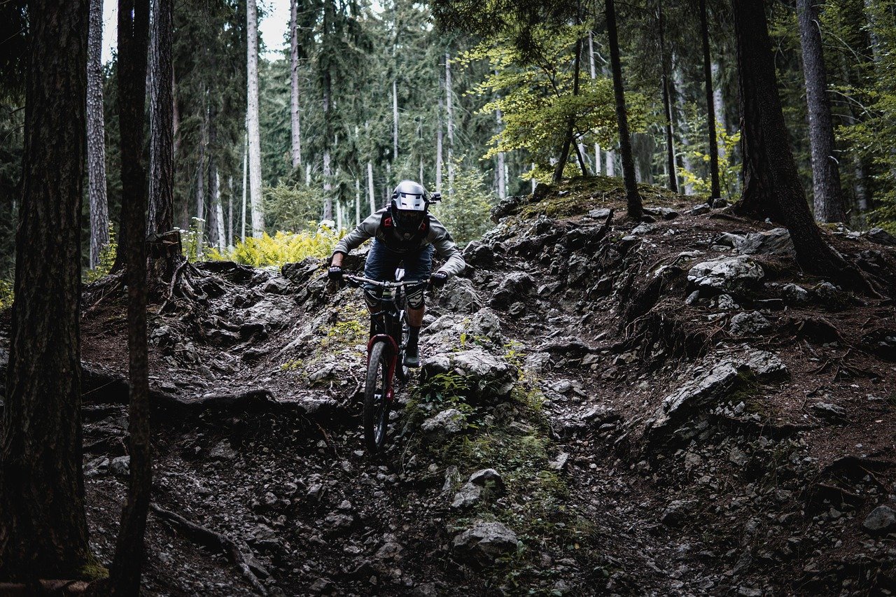 Cycliste équipé roulant sur un chemin en sous-bois