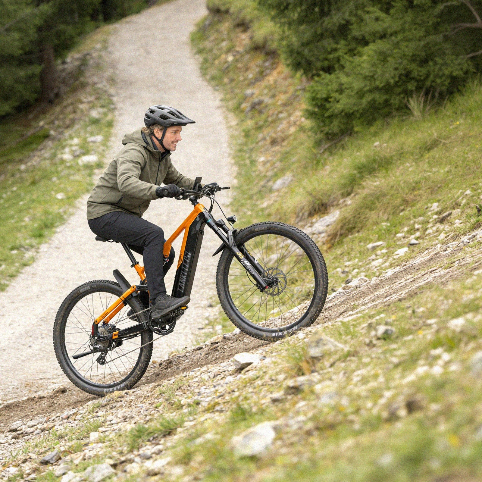 Vététiste en montée sur un chemin empierré avec le VTT électrique Lankeleisi MG600 Pro